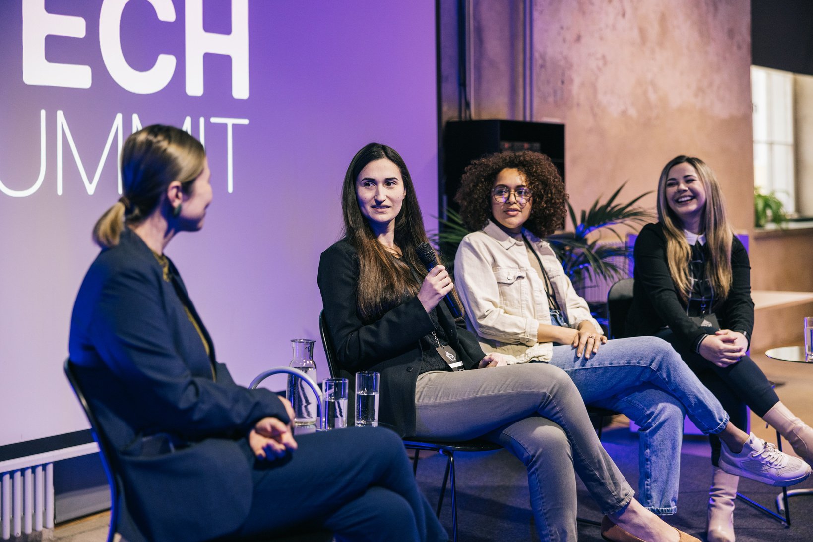 Group of multi-ethnic businesswoman making a great panel discussion on stage.